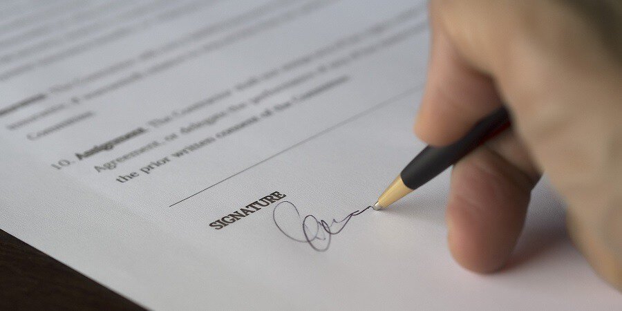 Pictured: signing a real estate lease. Many renters do not know you can re-negotiate the maintenance terms.