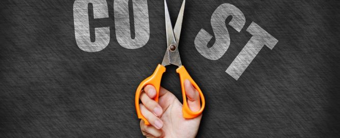 Pictured: a pair of hands holding scissors are cutting through the word "cost".